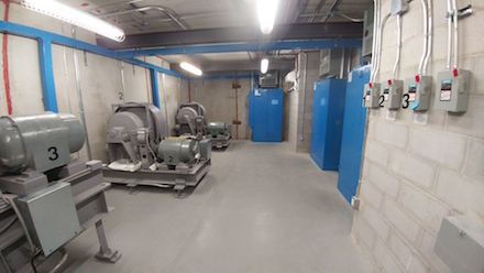 Elevator Machine Room - Large Concrete room with three elevator machines